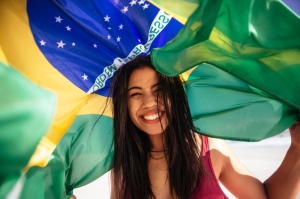Cheering woman under brazilian flag